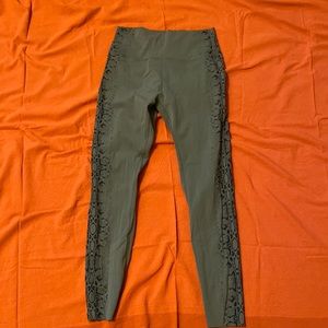 Green leggings with snake print down the side